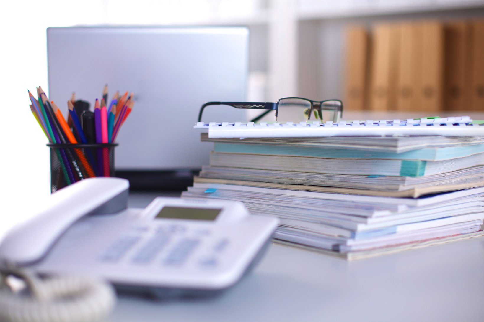 Group of multicolored office folders and glasses